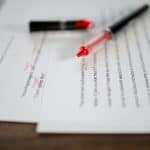 Typed papers with red pen